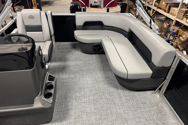 Slide: The Image of 2026 Sun Tracker Party Barge 16 DLX interior with gray seating and helm station. - 8