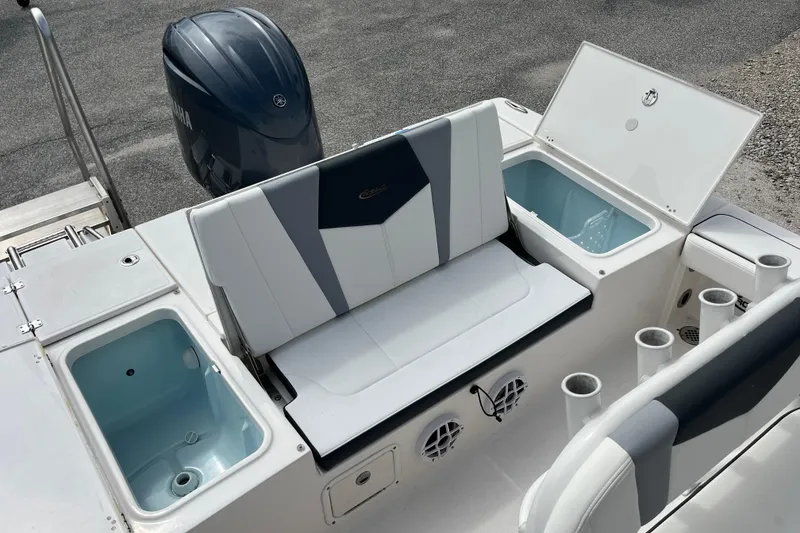 Slide: The Image of 2024 Robalo 226 Cayman boat interior with seating, storage compartments, and Yamaha outboard motor. - 10