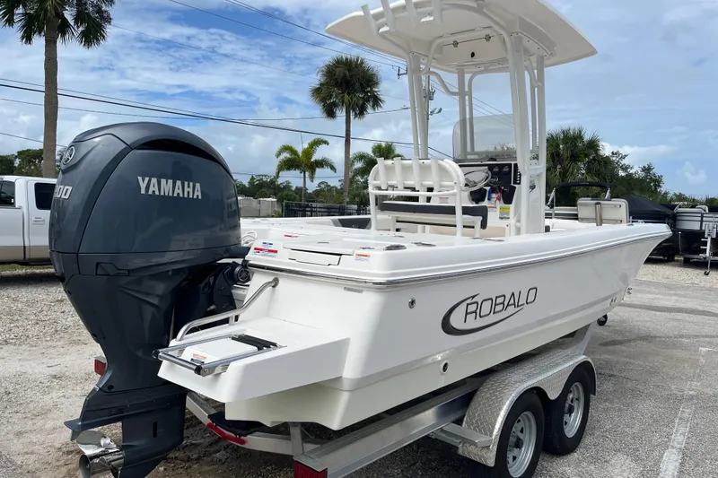 Slide: The Image of 2024 Robalo 226 Cayman boat with Yamaha engine on trailer, parked outdoors. - 4