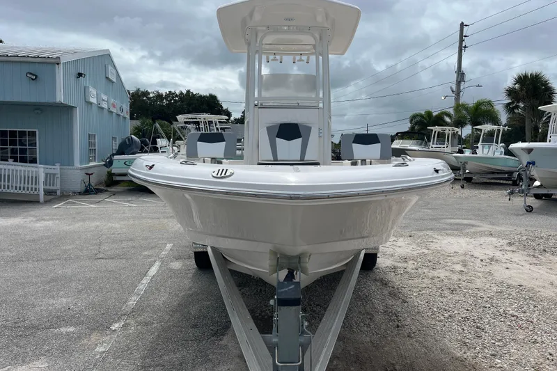 Slide: The Image of 2024 Robalo 226 Cayman boat on trailer, displayed outdoors at a dealership. - 7