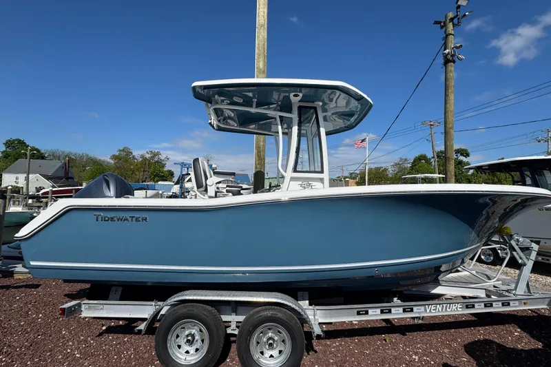 The Image of 2026 Tidewater 220 CC Adventure boat on trailer under clear blue sky. - 1