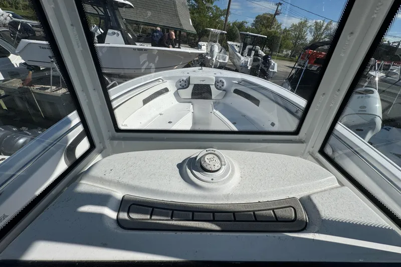 Slide: The Image of Interior view of 2026 Tidewater 220 CC Adventure boat, showcasing dashboard and controls. - 12
