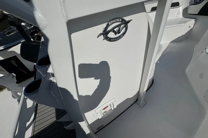 Slide: The Image of 2026 Tidewater 220 CC Adventure boat interior with logo and cup holders. - 16
