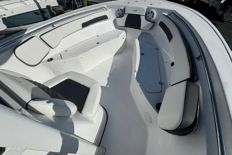 Slide: The Image of 2026 Tidewater 220 CC Adventure boat interior with cushioned seating and storage compartments. - 17