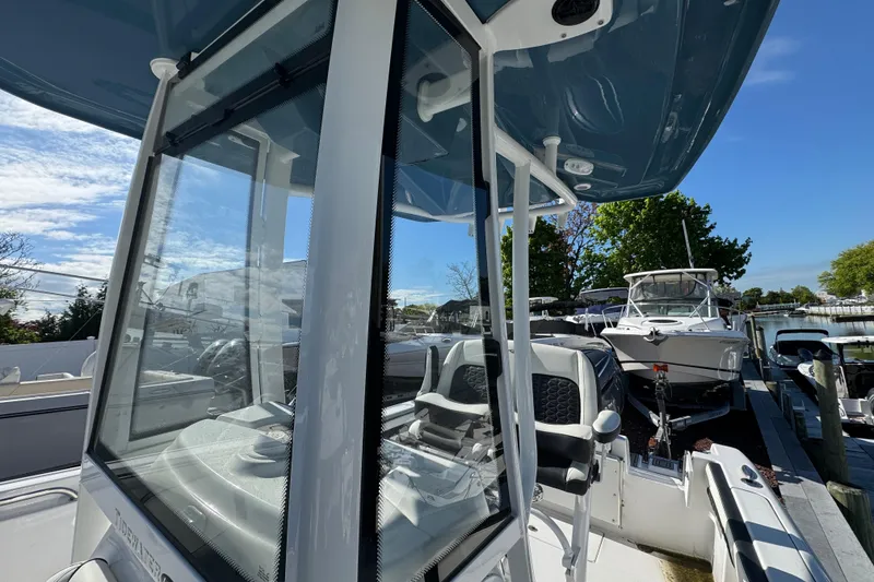 Slide: The Image of 2026 Tidewater 220 CC Adventure boat docked, showcasing sleek design and modern features. - 21