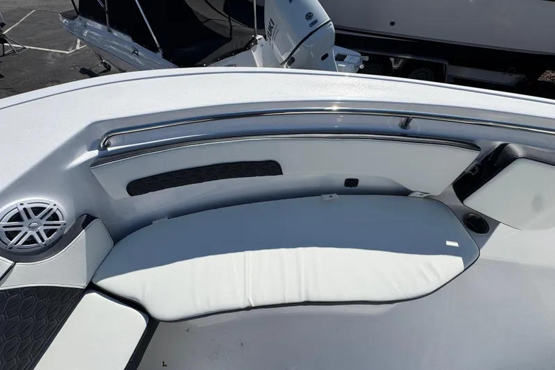 Slide: The Image of 2026 Tidewater 220 CC Adventure boat interior with cushioned seating and speaker. - 24