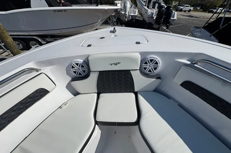 Slide: The Image of 2026 Tidewater 220 CC Adventure boat interior with cushioned seating and speakers. - 25