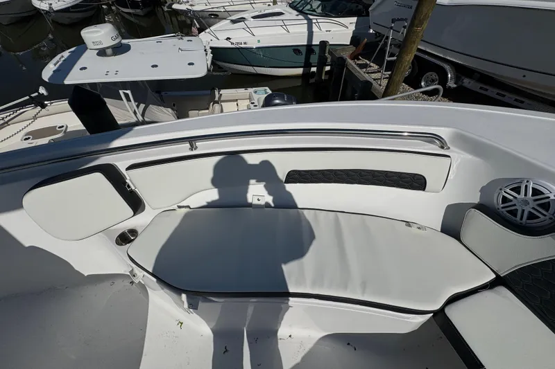 Slide: The Image of 2026 Tidewater 220 CC Adventure boat interior with cushioned seating and speaker. - 26