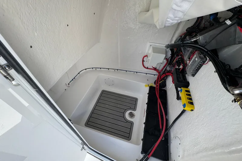 Slide: The Image of Interior view of 2026 Tidewater 220 CC Adventure boat's electrical compartment. - 27