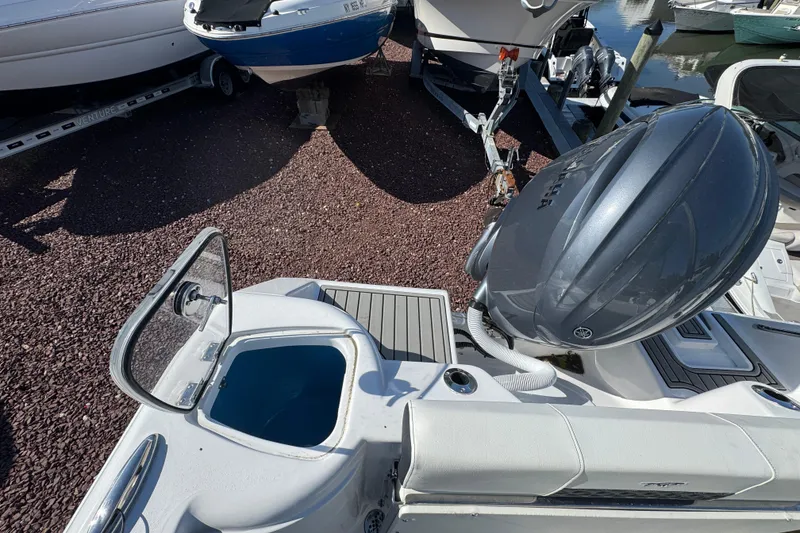 Slide: The Image of 2026 Tidewater 220 CC Adventure boat with Yamaha outboard engine, docked on gravel. - 5