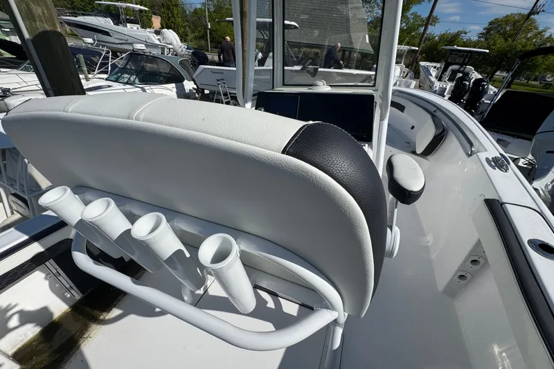 Slide: The Image of 2026 Tidewater 220 CC Adventure boat interior with rod holders and seating. - 6