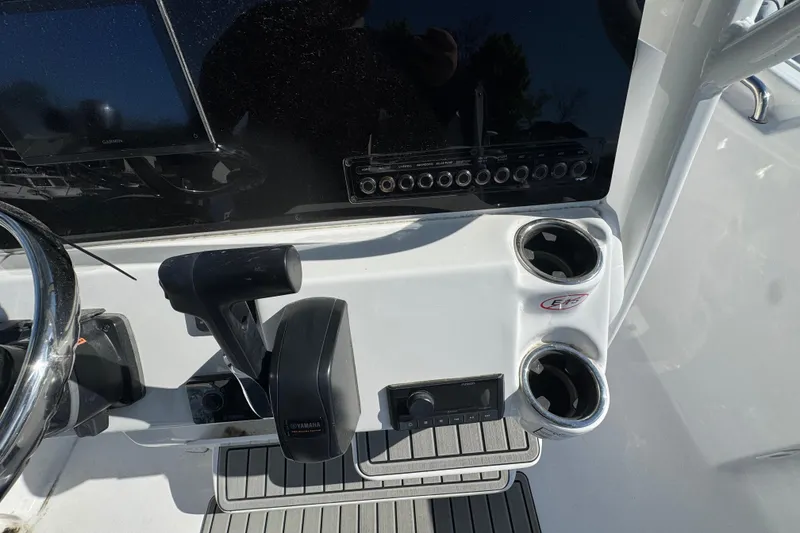 Slide: The Image of Center console of 2026 Tidewater 220 CC Adventure boat with controls and cup holders. - 9