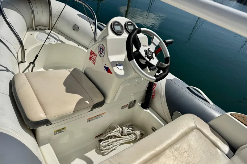 Slide: The Image of Interior view of a 1996 Grand Banks 46 Heritage CL boat with steering wheel and seating. - 11