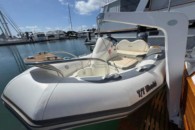 Slide: The Image of Inflatable boat docked beside a 1996 Grand Banks 46 Heritage CL yacht in a marina. - 13