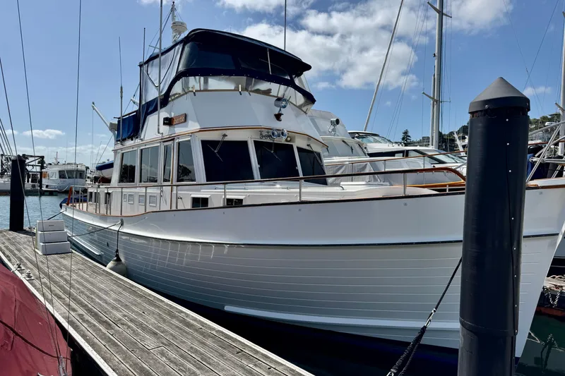Slide: The Image of 1996 Grand Banks 46 Heritage CL yacht docked at marina under blue sky. - 2