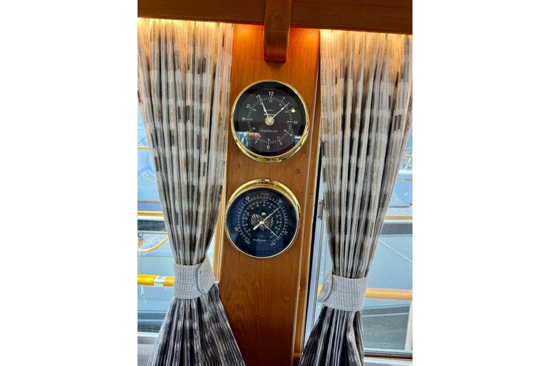 Slide: The Image of Nautical instruments on 1996 Grand Banks 46 Heritage CL, framed by elegant curtains. - 20
