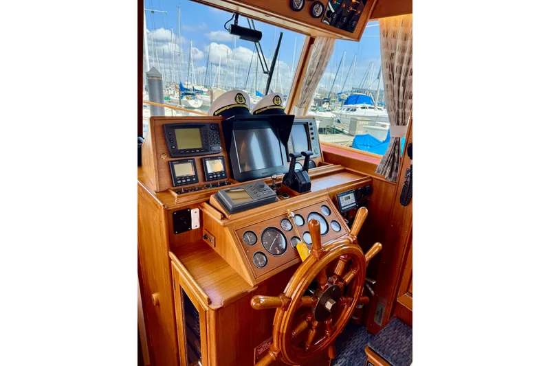 Slide: The Image of Helm of 1996 Grand Banks 46 Heritage CL with wooden wheel and navigation instruments. - 24