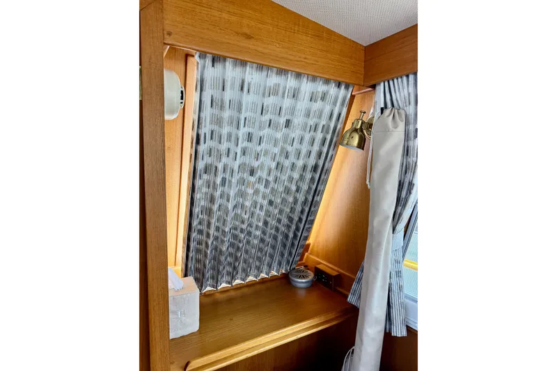 Slide: The Image of Interior of 1996 Grand Banks 46 Heritage CL with wood paneling and patterned curtains. - 26