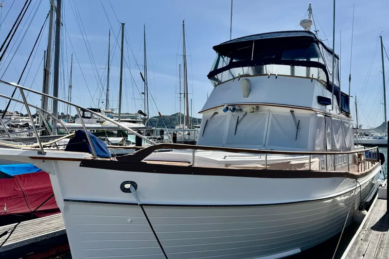 Slide: The Image of 1996 Grand Banks 46 Heritage CL yacht docked at marina, surrounded by sailboats. - 3