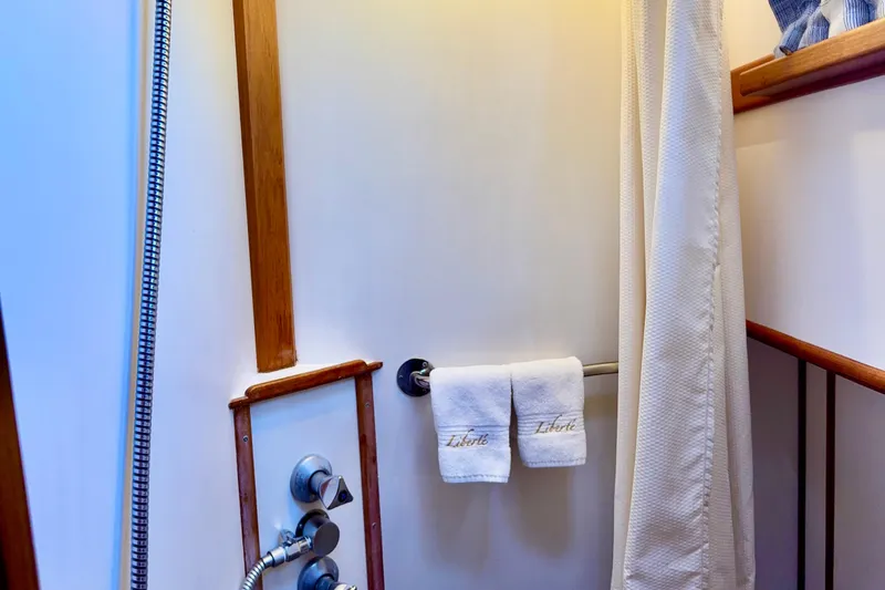 Slide: The Image of Shower area in 1996 Grand Banks 46 Heritage CL yacht with towels and wooden accents. - 33