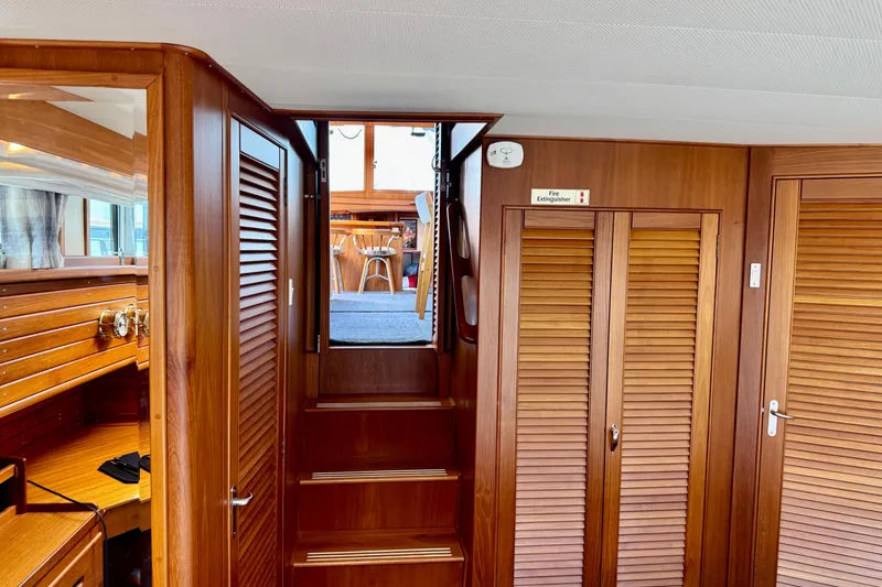 Slide: The Image of Interior of 1996 Grand Banks 46 Heritage CL yacht with wooden cabinetry and stairs. - 35