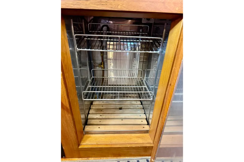 Slide: The Image of Empty wooden cabinet with metal shelves inside a 1996 Grand Banks 46 Heritage CL yacht. - 44