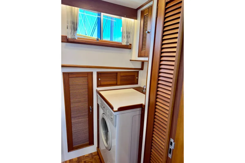 Slide: The Image of Laundry area with wooden cabinetry on a 1996 Grand Banks 46 Heritage CL yacht. - 45