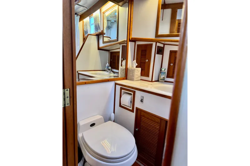 Slide: The Image of Bathroom interior of 1996 Grand Banks 46 Heritage CL yacht, featuring wood accents and modern amenities. - 46