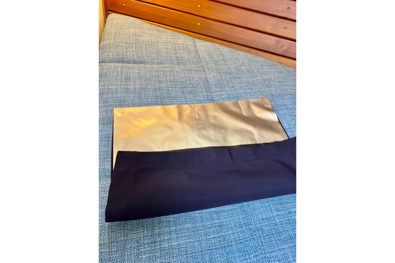 Slide: The Image of Blue fabric and foil on a wooden bench inside a 1996 Grand Banks 46 Heritage CL. - 50