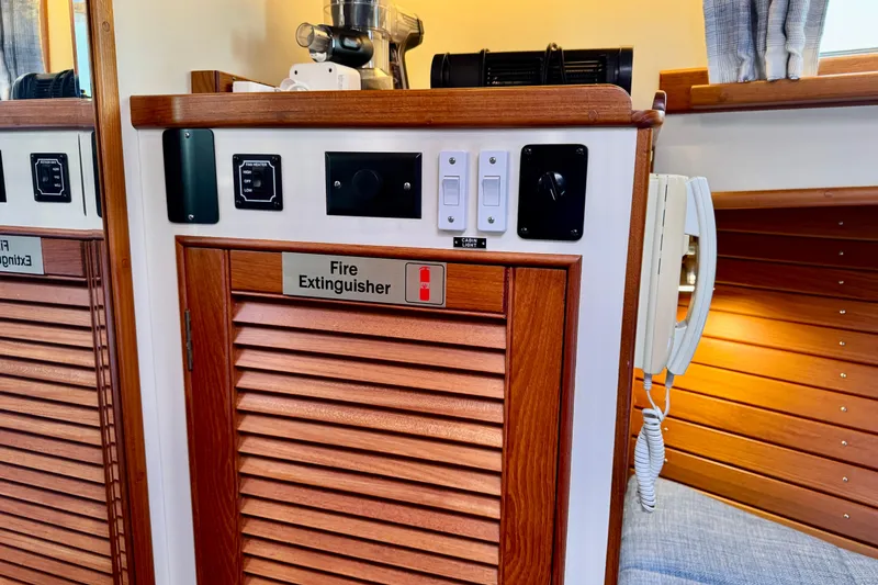 Slide: The Image of Interior of 1996 Grand Banks 46 Heritage CL with fire extinguisher cabinet and control panel. - 52