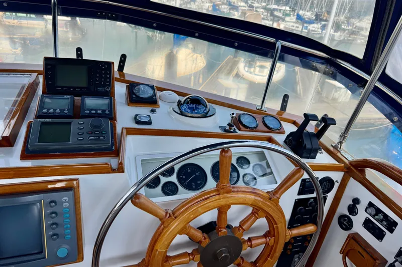 Slide: The Image of Helm of 1996 Grand Banks 46 Heritage CL with navigation instruments and wooden steering wheel. - 55