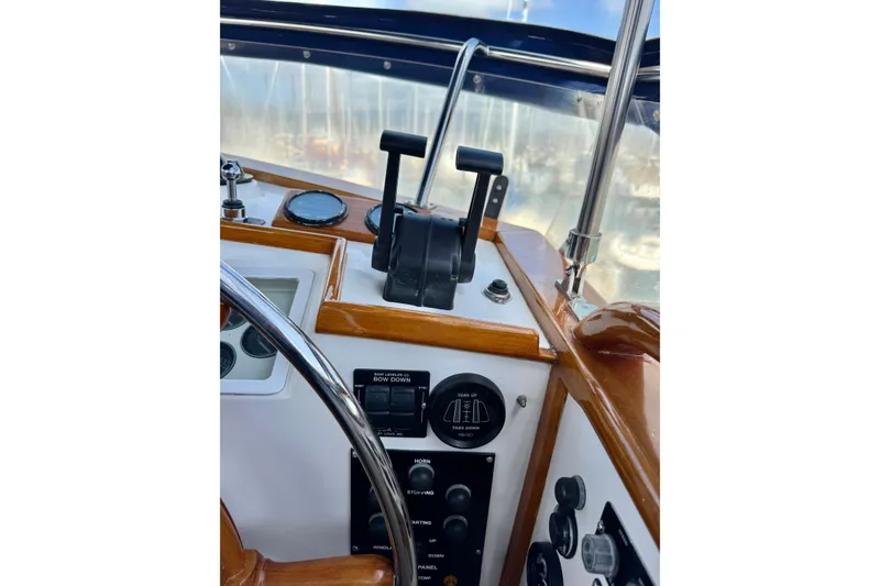 Slide: The Image of Helm controls of a 1996 Grand Banks 46 Heritage CL yacht, featuring throttle levers and gauges. - 59