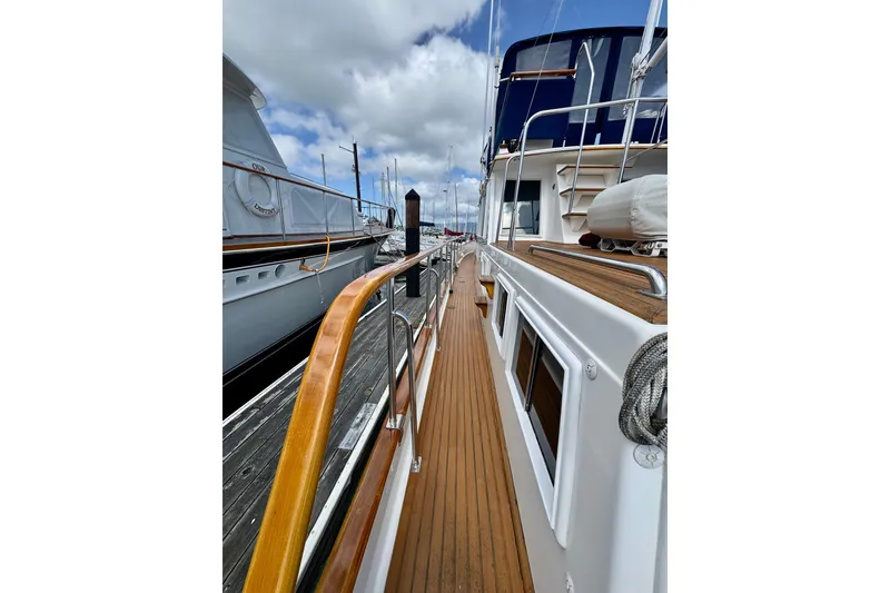 Slide: The Image of Side deck view of 1996 Grand Banks 46 Heritage CL yacht, featuring teak wood finish. - 6