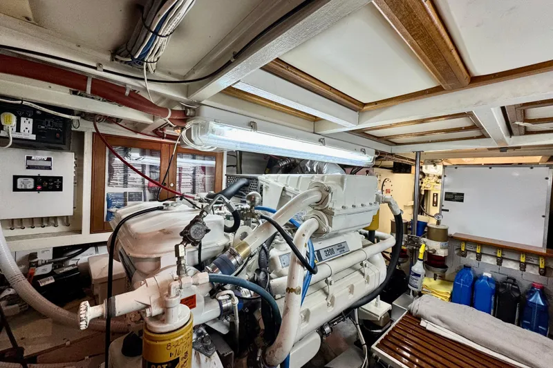 Slide: The Image of Engine room of 1996 Grand Banks 46 Heritage CL yacht, featuring mechanical equipment and storage. - 65