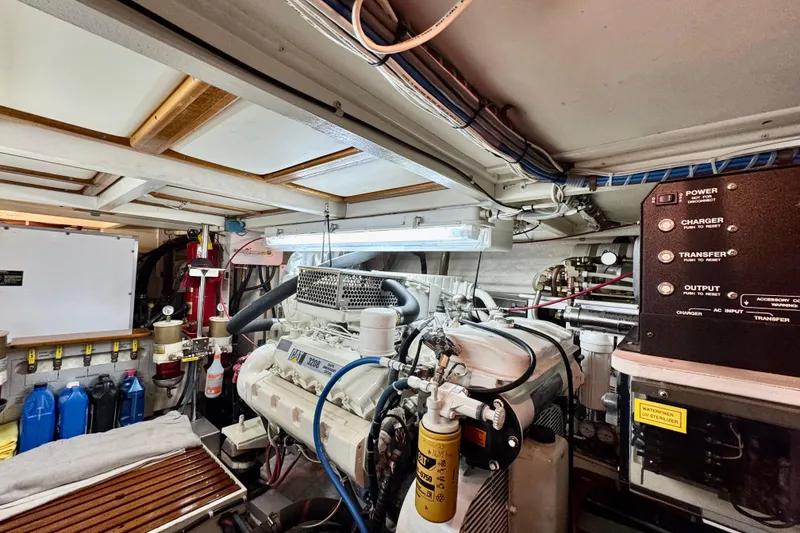 Slide: The Image of Engine room of a 1996 Grand Banks 46 Heritage CL yacht, featuring mechanical equipment and controls. - 66