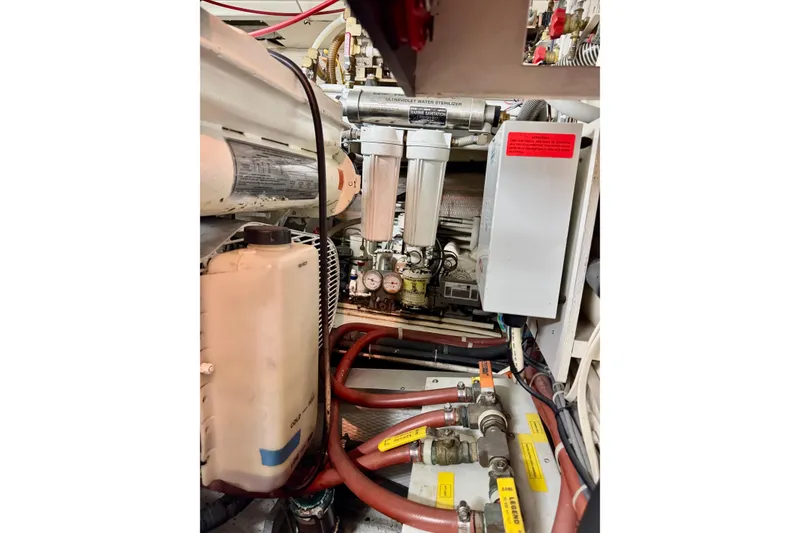Slide: The Image of Engine room of 1996 Grand Banks 46 Heritage CL with mechanical components and hoses. - 68