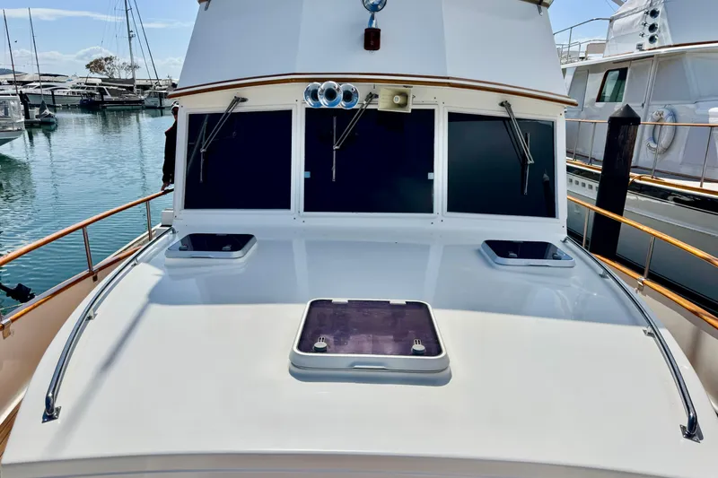 Slide: The Image of 1996 Grand Banks 46 Heritage CL yacht deck with windows and railing in marina. - 7