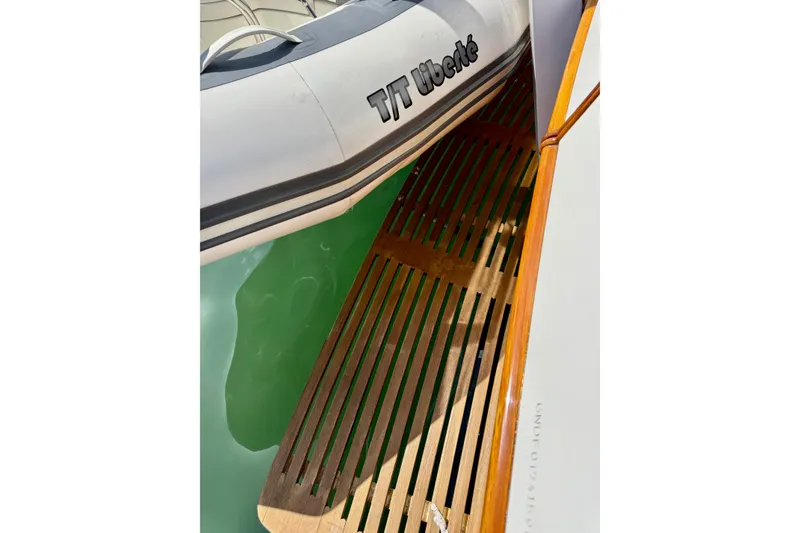 Slide: The Image of Wooden deck of 1996 Grand Banks 46 Heritage CL with inflatable boat nearby. - 71