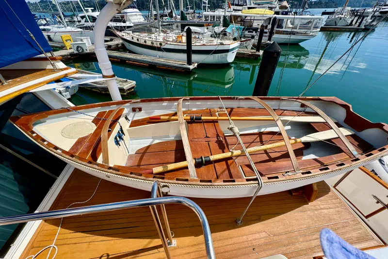 Slide: The Image of Wooden dinghy on a 1996 Grand Banks 46 Heritage CL yacht, docked at a marina. - 72