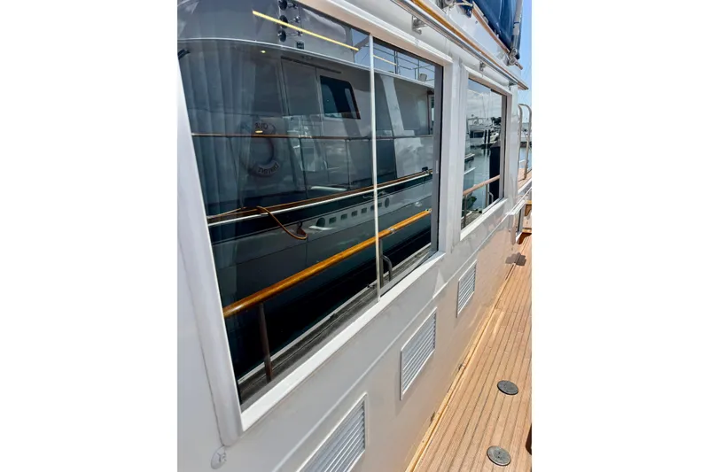 Slide: The Image of Side view of 1996 Grand Banks 46 Heritage CL yacht with reflective windows. - 73