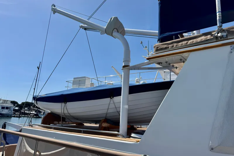 Slide: The Image of Grand Banks 46 Heritage CL yacht, 1996 model, with a lifeboat on deck under clear skies. - 74