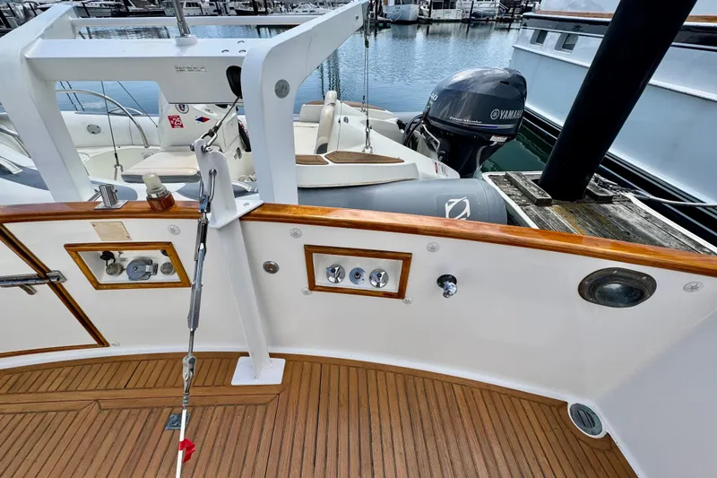 Slide: The Image of Deck view of a 1996 Grand Banks 46 Heritage CL yacht, featuring teak flooring and marine equipment. - 78