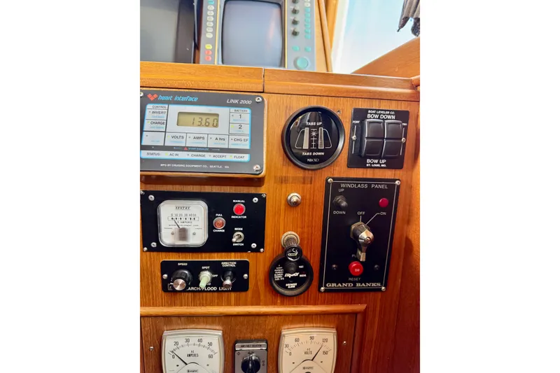 Slide: The Image of Control panel of a 1996 Grand Banks 46 Heritage CL yacht, featuring various gauges and switches. - 81