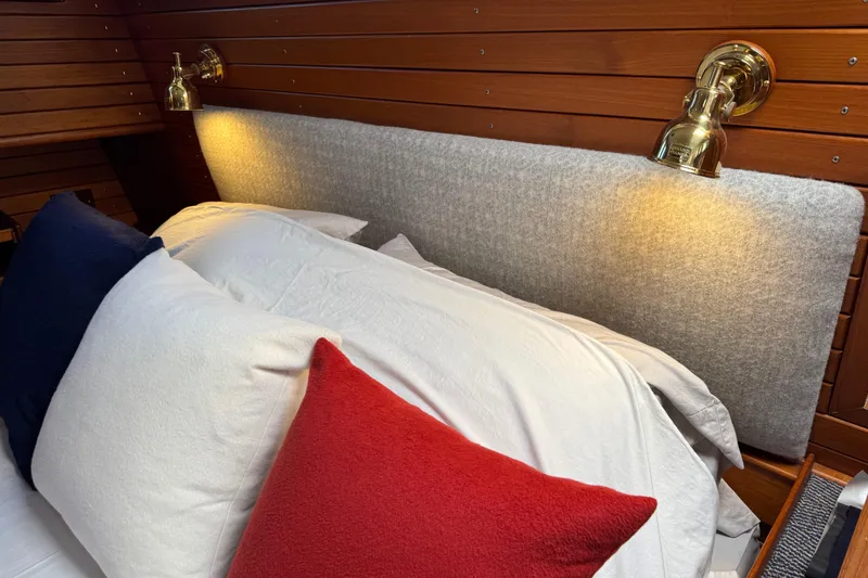 Slide: The Image of Cozy cabin interior of 1996 Grand Banks 46 Heritage CL with elegant bedding and brass lighting. - 89