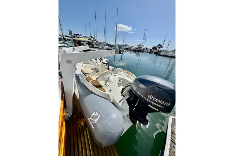 Slide: The Image of A 1996 Grand Banks 46 Heritage CL yacht docked with a Zodiac tender and Yamaha motor. - 9