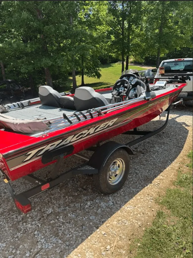 Slide: The Image of Red 2017 Tracker Pro Team 175 TXW boat on trailer outdoors. - 2