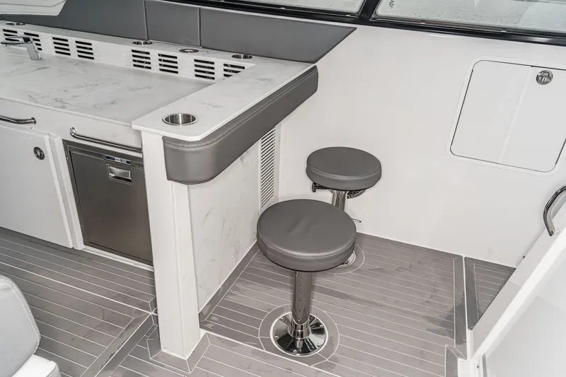 Slide: The Image of Interior of 2022 Cruisers 42 GLS with bar stools and counter. - 34