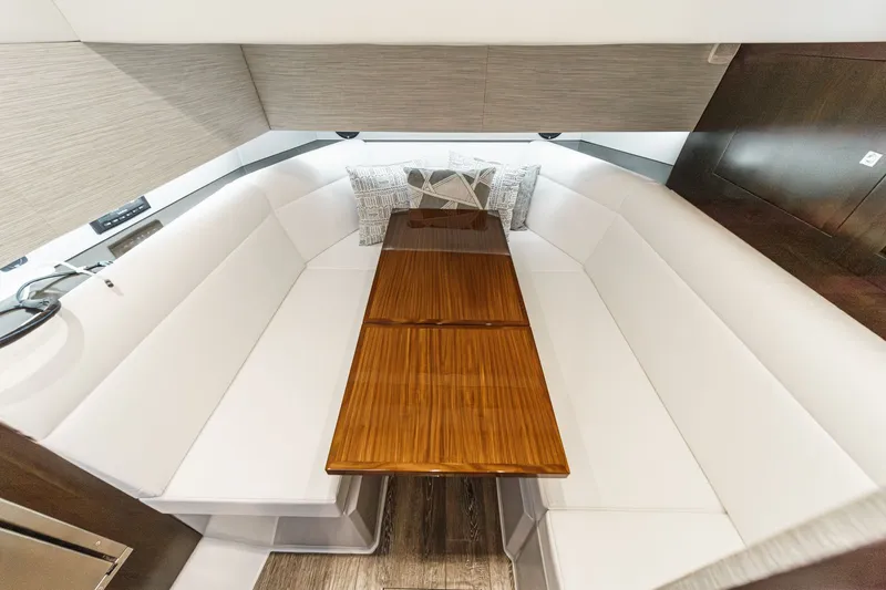 Slide: The Image of Interior of 2022 Cruisers 42 GLS with white sofa and wooden table. - 46