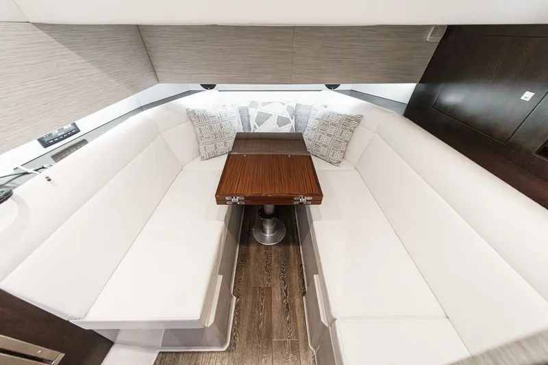 Slide: The Image of Interior of 2022 Cruisers 42 GLS with white sofa and wooden table. - 47