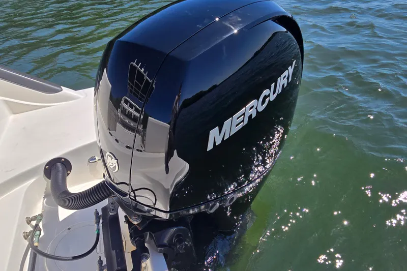 Slide: The Image of 2023 Bayliner Trophy T22CC with Mercury outboard engine on water. - 22